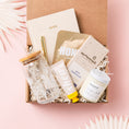 Load image into Gallery viewer, a box of personal care items on a pink background