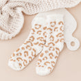 Load image into Gallery viewer, a pair of white and gold leopard print mitts next to a white knitted