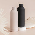 Load image into Gallery viewer, a couple of black and white bottles sitting next to each other