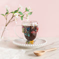 Load image into Gallery viewer, a cup of hot chocolate with flowers in it