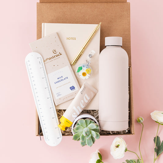 a box of personal care items on a pink background