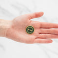 Load image into Gallery viewer, a person's hand holding a green and yellow badge
