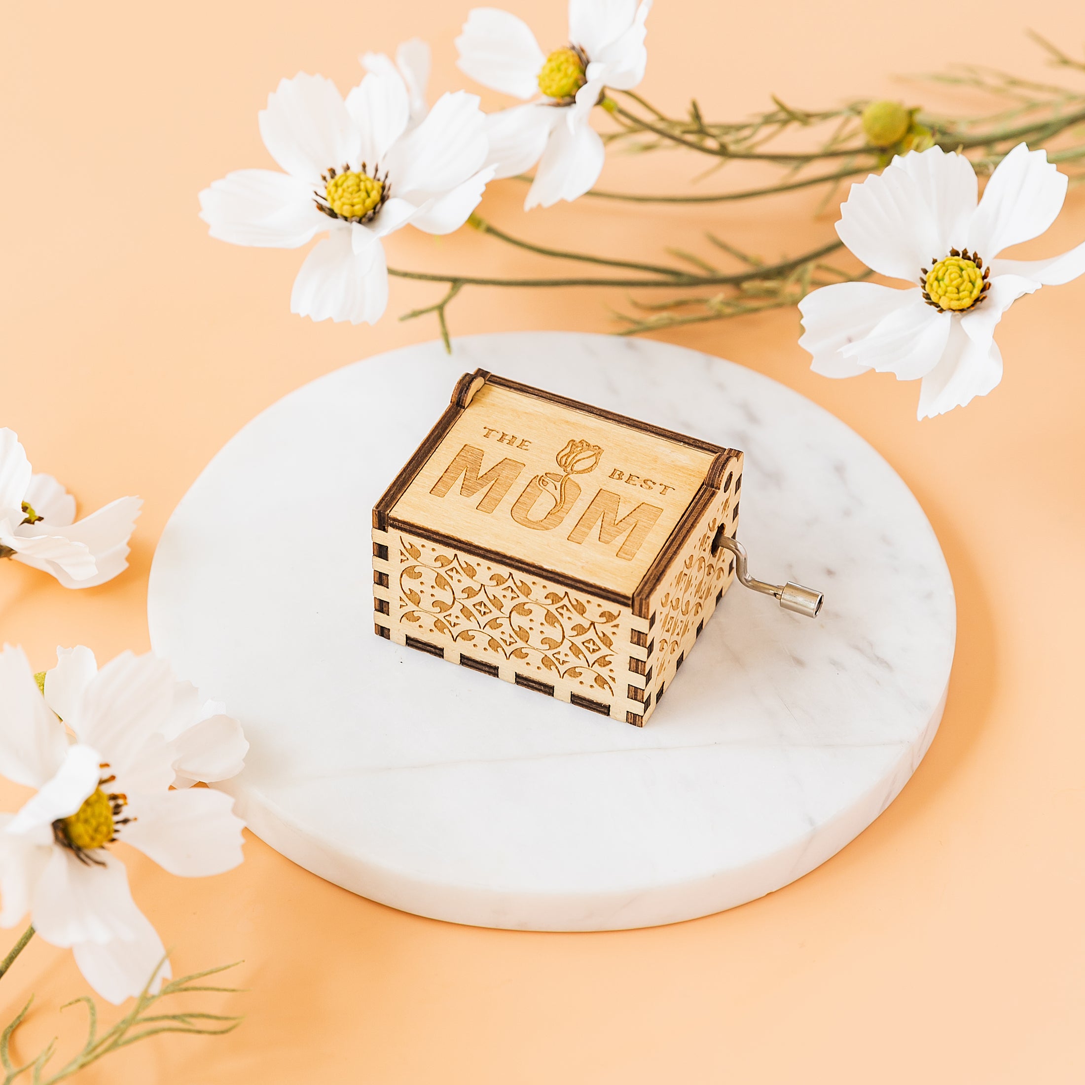 a mother's day card box sitting on a marble coaster surrounded by flowers