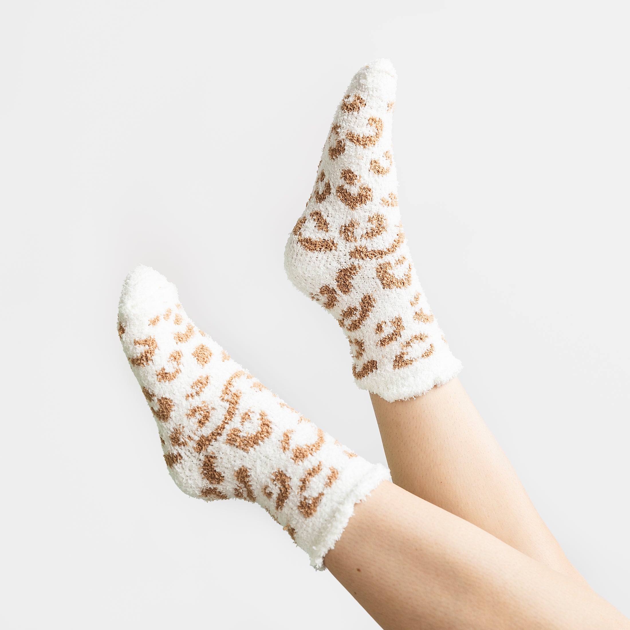 a woman's legs with leopard print socks