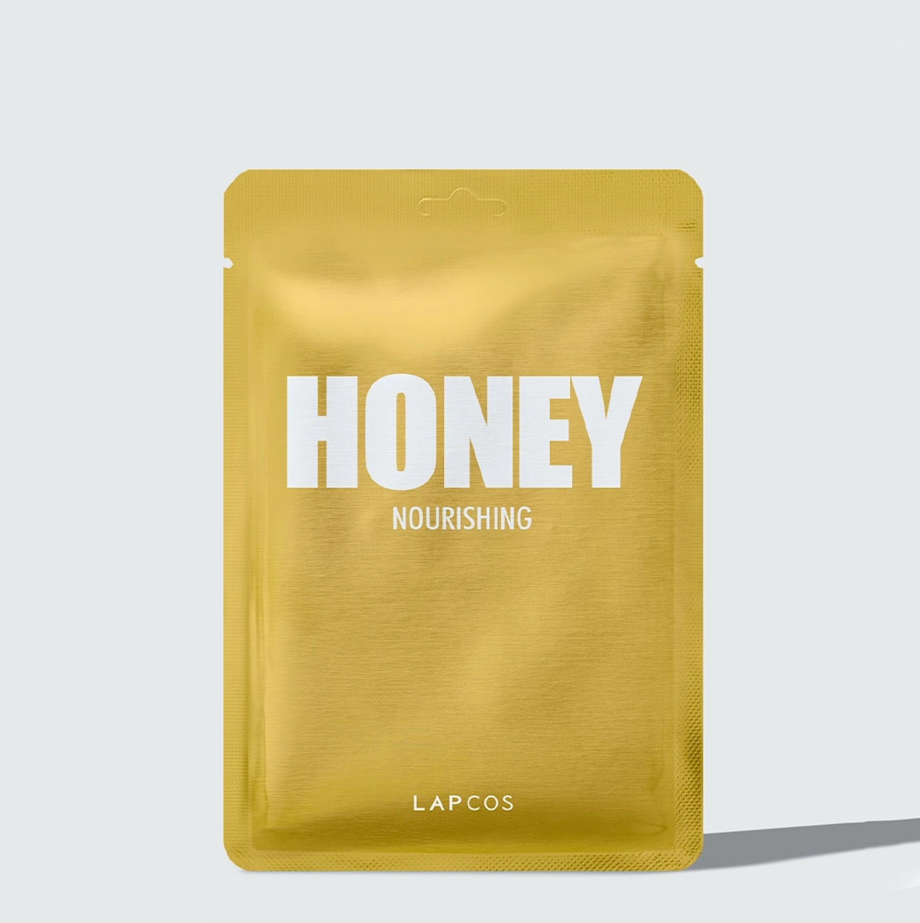 a packet of honey nourishing on a white background