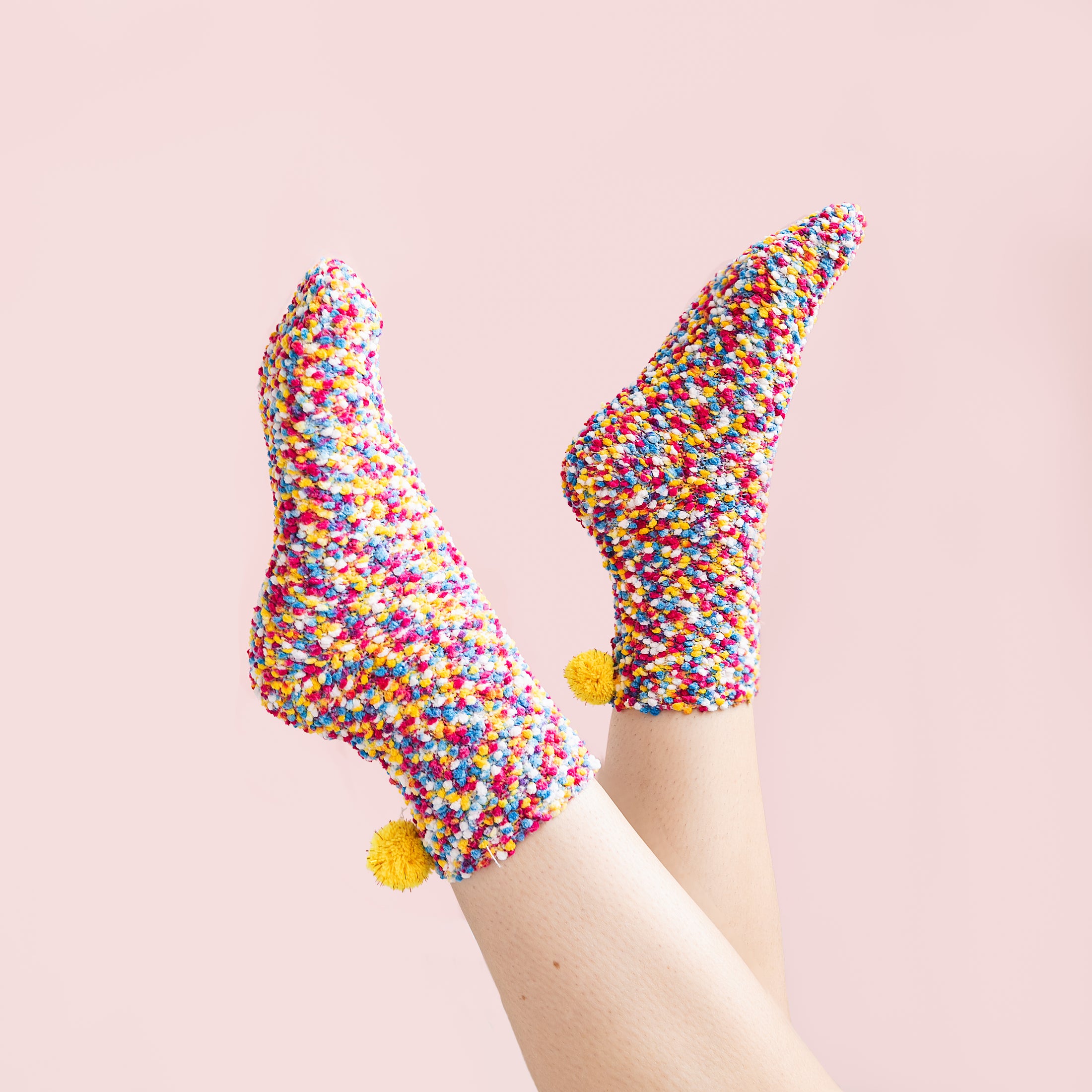 a pair of feet with colorful sprinkles on them