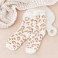 Load image into Gallery viewer, a pair of white and gold leopard print mitts next to a white knitted
