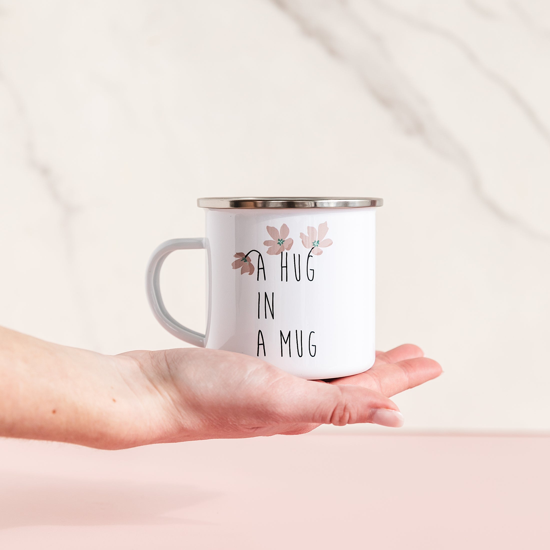 a hand holding a coffee mug with a quote on it
